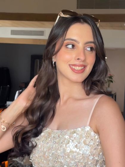 A candid moment with Yashodhra Seth. The soft waves and side-swept front create a look that is both elegant and effortlessly chic.