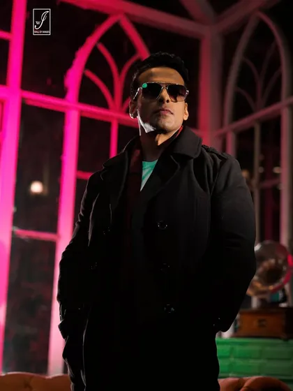 A cinematic shot of fitness personality Yatinder Singh. The moody lighting and trench coat create a powerful, iconic look suitable for a movie poster or major brand campaign.