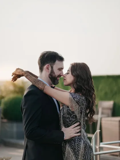 A classic romantic pose, with the couple close together, nose-to-nose. The soft, golden light of the setting sun adds a warm glow to this beautiful pre-wedding portrait.