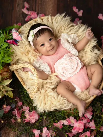 A sweet, gentle smile from this baby girl in her pink floral setting. These are the moments that make my heart melt.