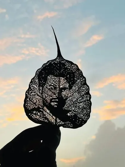 This is an example of a highly detailed custom portrait carved into a dried Peepal leaf. This style requires immense patience and focus, using the leaf's natural texture to create a unique piece of personal art.