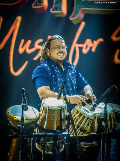 The joy of making music is evident on our percussionist's face during the Adani ACC Cement show.