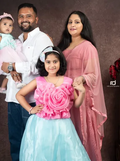 I believe family portraits should be a celebration of your unique bond. Here, a beautiful family with their two daughters, dressed in coordinating pink and blue, created a memory to cherish forever.