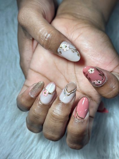 A beautiful and intricate design with a mix of colors, florals, glitter, and chrome details.