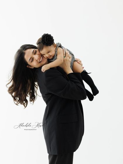 A warm, loving hug. This image captures the comfort and security a baby feels in her mother's arms, a truly timeless and emotional moment.