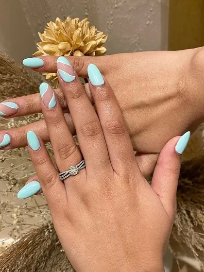 Obsessed with this abstract design in a cool minty blue. The negative space and wavy lines create a fun and modern look.