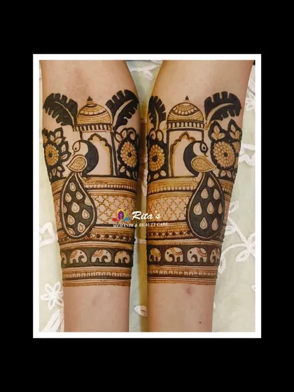 A close-up of the arm portion of the Maharashtrian bridal mehendi, highlighting the peacock and dome motifs.