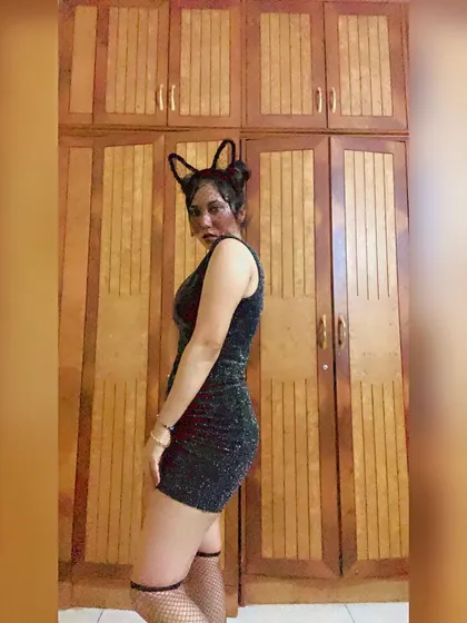 A side profile of my black cat outfit, showing the complete look with thigh-high socks and a sparkly dress.