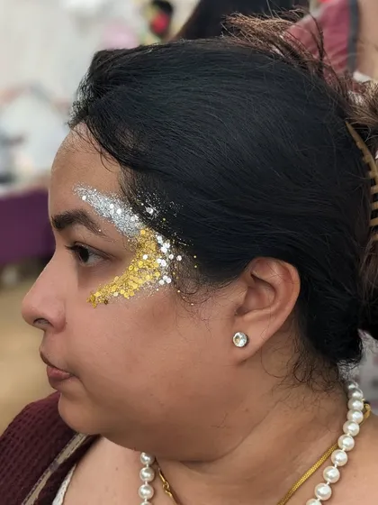 A crescent of gold and silver glitter, a simple and elegant design that makes a statement.