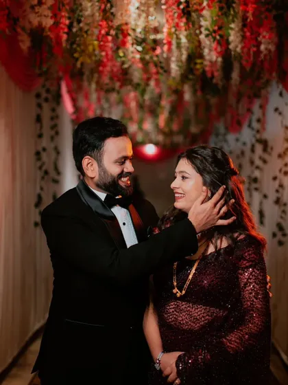 A tender moment captured beautifully. The groom's touch highlights the bride's flawless cheek makeup and radiant skin.