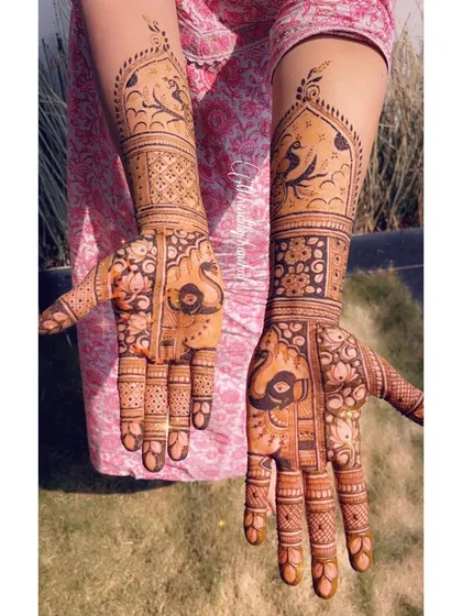 A bridal design with bold peacock and elephant figures, combined with heavy traditional patterns.