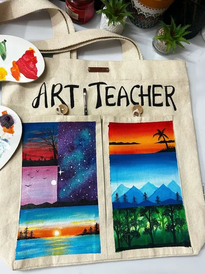 Another look at the hand-painted tote bag, styled with my art palette. This shows the functionality and artistic flair of the bag, which has outer pockets perfect for carrying brushes or other small items.