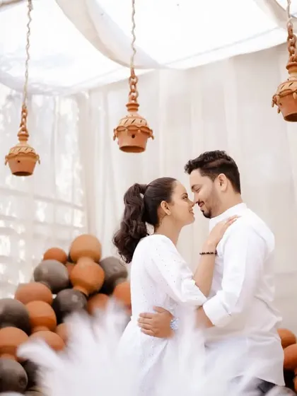 A close-up of the couple's embrace, with the soft lighting and unique decor creating a dreamy and romantic pre-wedding photograph.