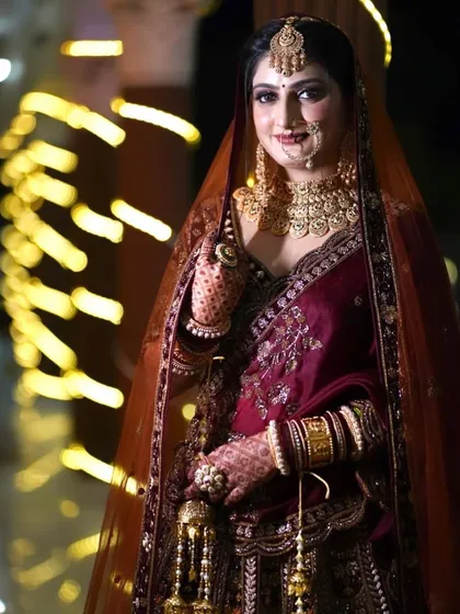 My pretty bride Preeti, looking stunning in her maroon velvet outfit. The bokeh lights add a magical touch.