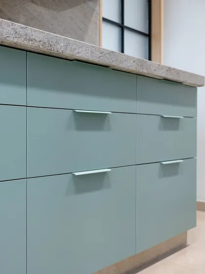 A detail of the mint green drawers, showing the clean lines and simple, elegant hardware. This pastel finish brings a light, airy feel to the kitchen, perfect for creating a space that feels both fresh and modern.