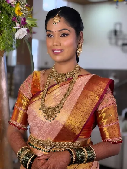 Another angle of Ranjitha's classic South Indian bridal look. The focus is on creating a balanced and elegant profile, with perfectly defined eyes and lips that complement her grand attire.