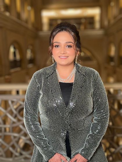 The final look for the evening event. The silver shimmer jacket is complemented by soft, elegant makeup that enhances her natural beauty.