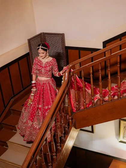 The bride's descent down the stairs. This is a classic, cinematic moment, capturing her grace and the beauty of her full bridal attire in motion.