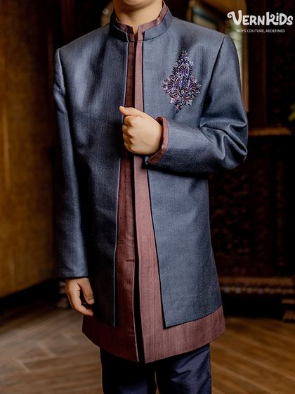 A closer look at the layered Indo-western outfit from our Jashn Collection. This angle highlights the rich texture of the fabric and the precisely embroidered motif on the chest.