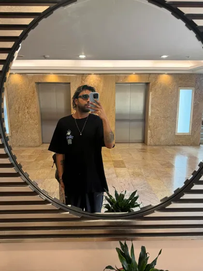 A mirror selfie from a hotel lobby, capturing the on-the-go lifestyle of a touring DJ.