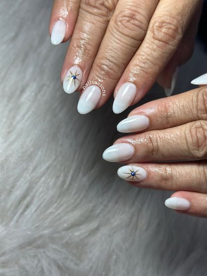 The gold and blue details of the evil eye design stand out beautifully against the soft white base.