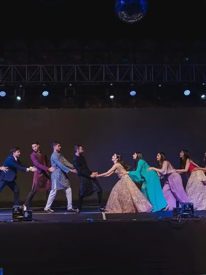 Holding hands, they danced the night away. This tug-of-war between the bride's side and groom's side was a fun, playful start to a performance that celebrated their union.
