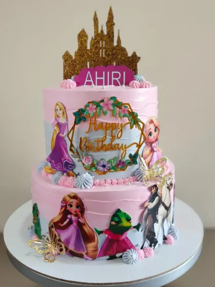 A magical two-tier Rapunzel cake. This princess theme is brought to life with edible images of the characters and a sparkling castle topper.