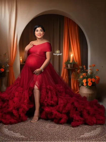 A radiant solo portrait in a stunning red gown, set against a warm, candlelit Moroccan-themed backdrop.
