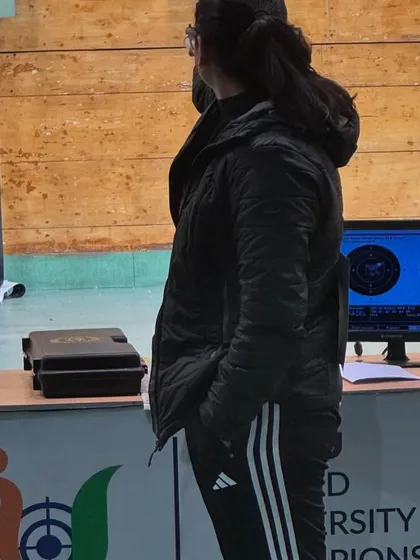 A student stands ready at the firing point, with electronic targets displaying her shots. We use modern technology to provide instant feedback and track progress.