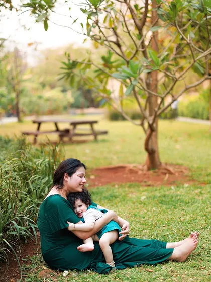 A simple, loving embrace between a mother and her child on the grass. My simple lifestyle sessions focus on these quiet, candid moments of connection in a natural setting.