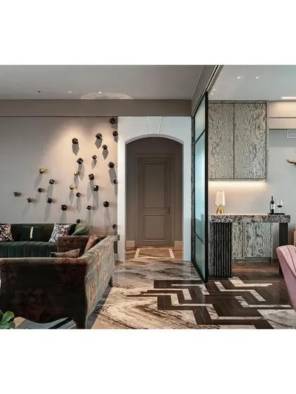 This image shows the connection between the formal living area, the dining space, and the den. The transition from marble to a dark herringbone wood floor was a challenging detail that defines the different zones while maintaining an open, flowing feel.
