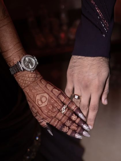 A classic hand-holding shot that beautifully showcases the bride's engagement mehendi and its amazing color.