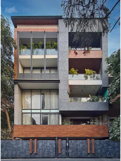 This residential facade exudes modernity and sophistication. The thoughtful placement of glass, the artistic use of perforated aluminum jali, and the incorporation of high-pressure laminate make it a standout example of modern residential architecture.