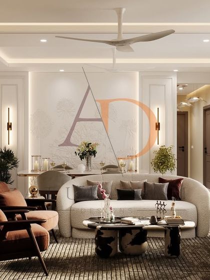 A wide shot of the modern glam living room, showcasing the curved boucle sofas, rust-toned armchairs, and layered ceiling lighting.