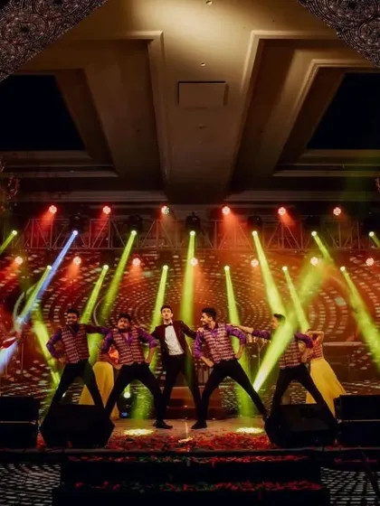 A wide shot of the groom's solo performance, showing the scale of the stage, lighting, and backup dancers that we coordinate for a full production.