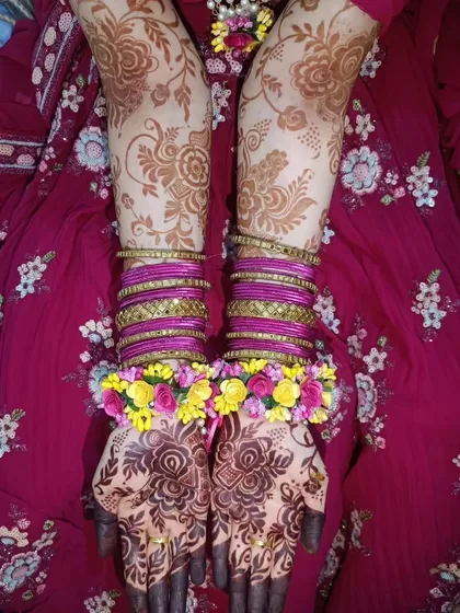 A beautiful shot of my floral mehendi complemented by floral jewelry and bangles, perfect for a haldi or mehendi ceremony.