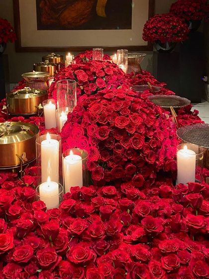 A wide shot of the magnificent rose-covered table, with our signature gold butterfly chafing dishes nestled among the flowers. This is the epitome of luxury event design.