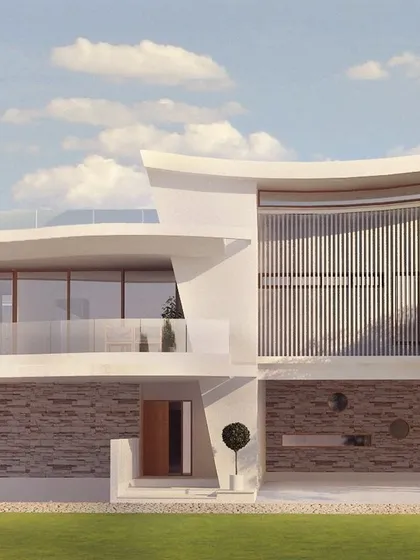 A closer view of the Thanisandra residence, highlighting the interplay between the curved upper level and the textured stone cladding on the ground floor. Vertical louvers provide privacy while allowing for filtered light.