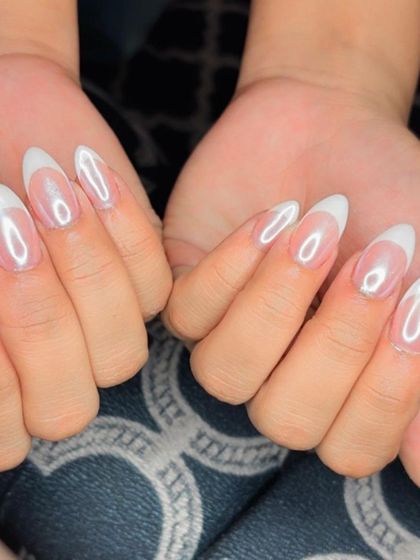 Both hands showcasing the elegant and shimmery French holochrome nails.