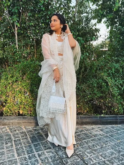 A full-length view of my cream-on-cream wedding guest look. The pearl choker and beaded bag were the perfect finishing touches.
