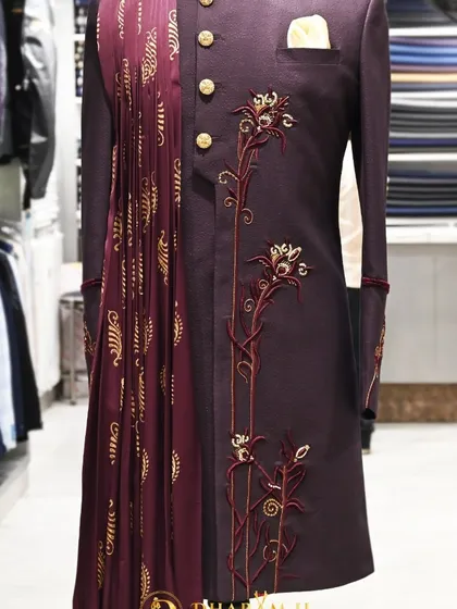 A repeat view of the wine-colored sherwani, emphasizing its distinctive design.