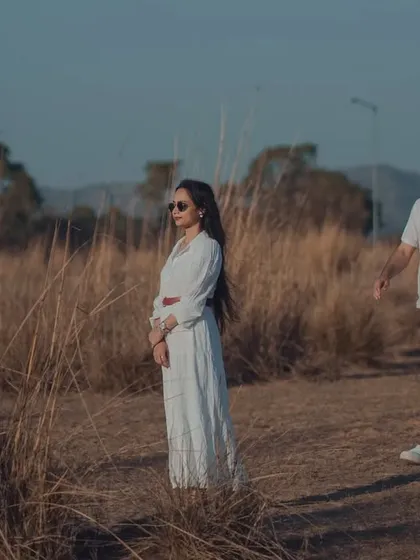 A candid walking shot during a golden hour photoshoot. The warm light and natural movement create a relaxed and authentic image that feels like a still from a movie.