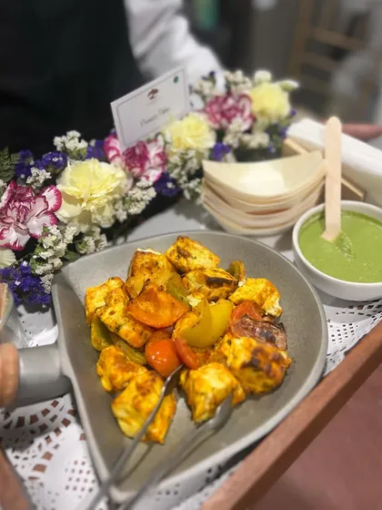 A server presenting our Paneer Tikka with green chutney. Our professional staff ensures that your guests are well taken care of throughout the event.