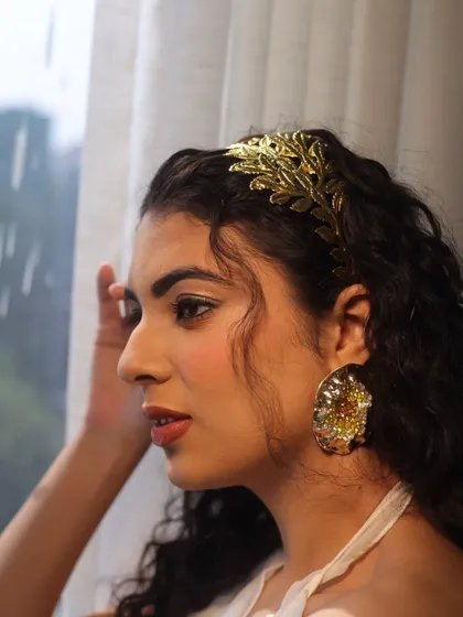 This profile shot highlights a sharp, winged eyeliner and beautifully sculpted cheekbones. The lighting catches the subtle glow on the skin, a key element of my camera-ready makeup style.