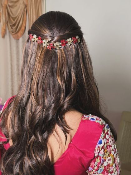 A half-updo with a beautiful red and gold floral hairband, a festive and colorful choice.
