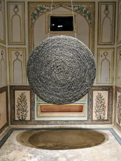 This circular sculpture, installed at Jaigarh Fort, represents the cyclical nature of existence. Made from countless cigarette butts, it hangs in a historic space, creating a dialogue between contemporary waste and timeless architecture.