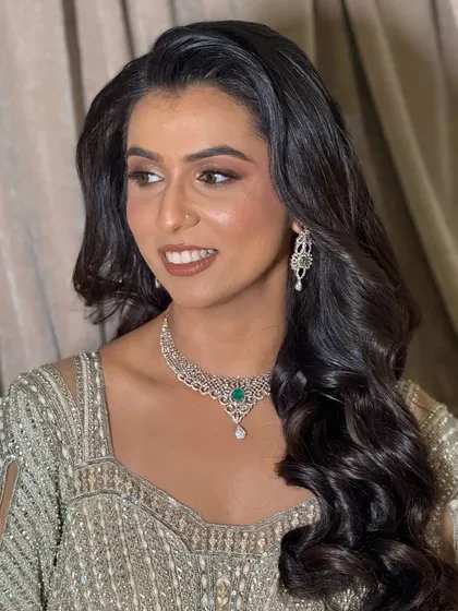 A side profile that highlights the soft waves in her hair and the beautiful glow on her skin.
