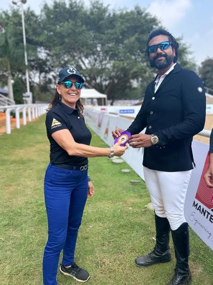 A coach receiving an award at the EPL Show. Our success is a team effort, and we recognize the hard work of our trainers who guide our riders to victory.