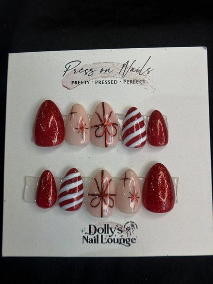 One of my popular Christmas press-on designs, featuring glittery red, candy stripes, and hand-painted bows.