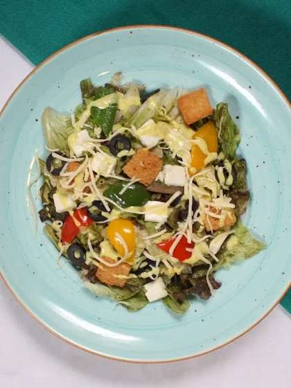 Our delectable Caesar Salad features fresh greens, crunchy croutons, and a zesty dressing, making it a perfect, light meal or a refreshing side.